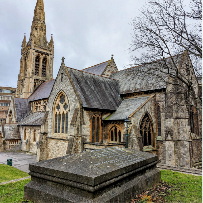 An image of Mary Shelley's tomb with St. Peter's church in the background.